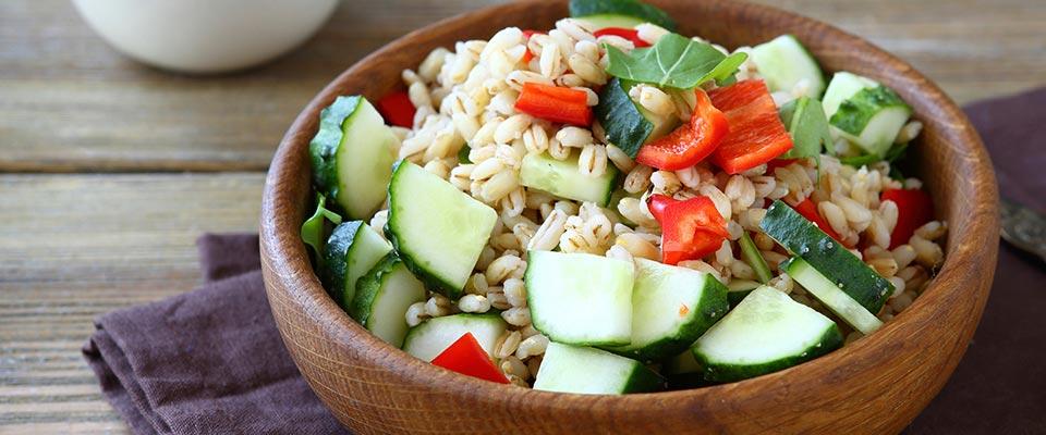 Bowl of pearl barley salad with vegetables