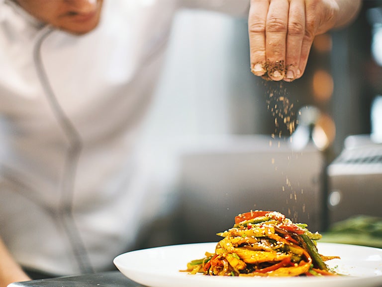 Chef garnishing dish