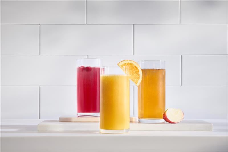 Vitality express beverages on white counter with white tile background