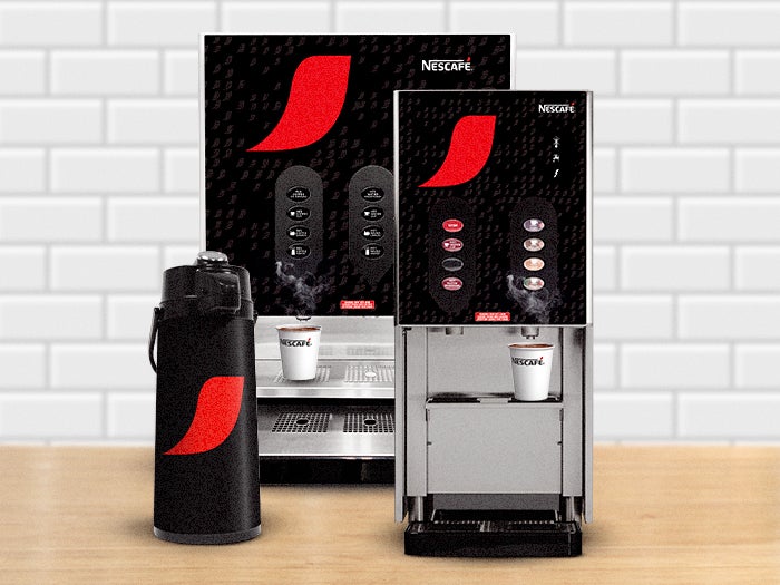 Nescafé coffee machines in two sizes, with a branded airpot beside them. Perfect for office break rooms or any workplace
