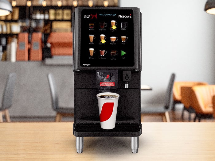 Nescafé specialty coffee machine with a touchscreen display, dispensing coffee into a branded cup. Ideal for cafes