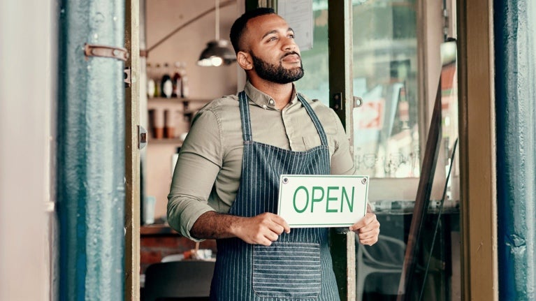 Man holding an Open sign