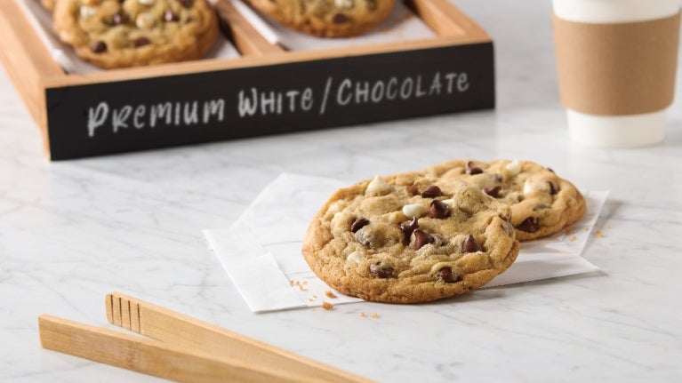 two chocolate chip cookies on a napkin