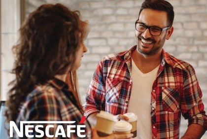 Nescafe man and woman with coffee in hand talkiing
