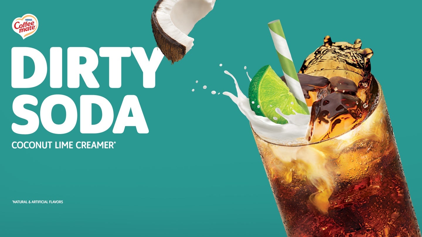 Image of a coffee mate dirty soda ad, displaying a refreshing drink in a glass with ice and a lime slice.